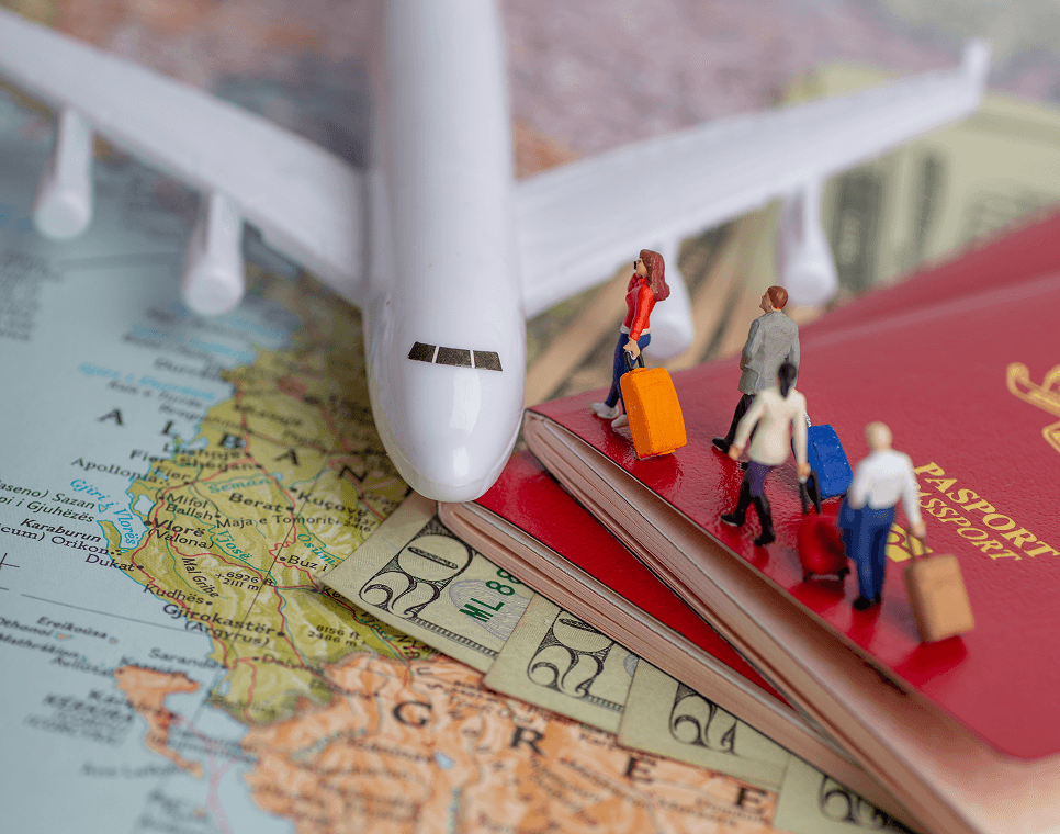 Toy airplane and passport with miniature travelers on a map
